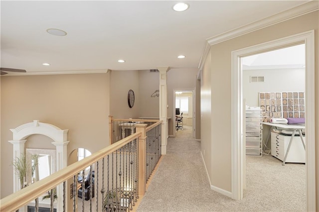 hall featuring crown molding and light colored carpet