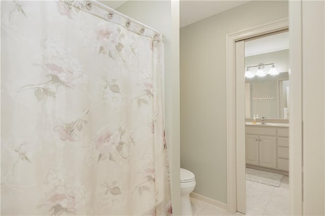 bathroom featuring toilet, tile patterned flooring, and vanity