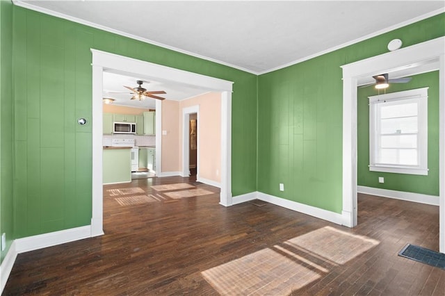 unfurnished room with ornamental molding, ceiling fan, and dark hardwood / wood-style floors