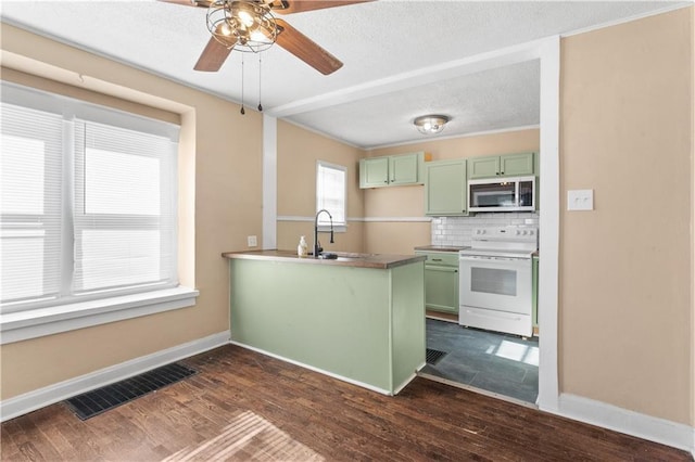 kitchen featuring kitchen peninsula, dark wood-type flooring, green cabinets, tasteful backsplash, and white range with electric stovetop