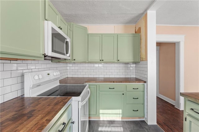 kitchen with white appliances, green cabinets, tasteful backsplash, and butcher block counters