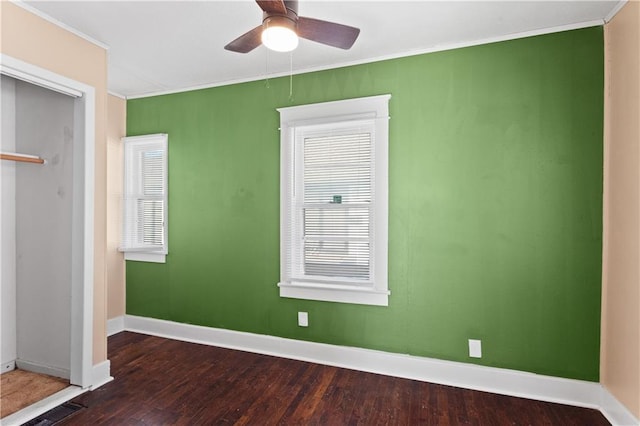 unfurnished room featuring ceiling fan, crown molding, and dark hardwood / wood-style floors