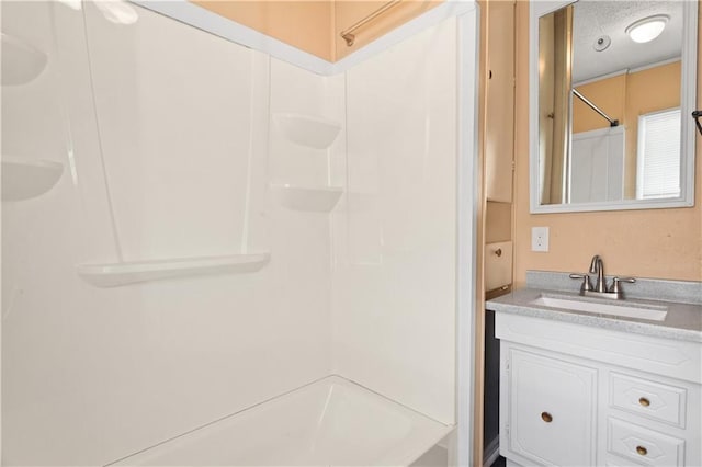 bathroom featuring a textured ceiling, shower / tub combination, and vanity