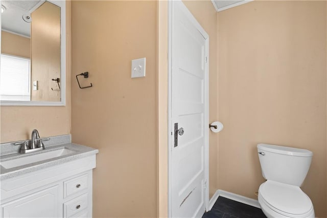 bathroom featuring toilet, tile patterned floors, and vanity