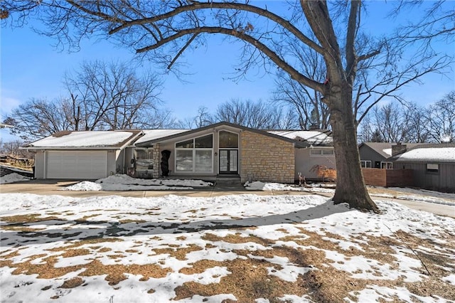 view of snowy exterior featuring a garage