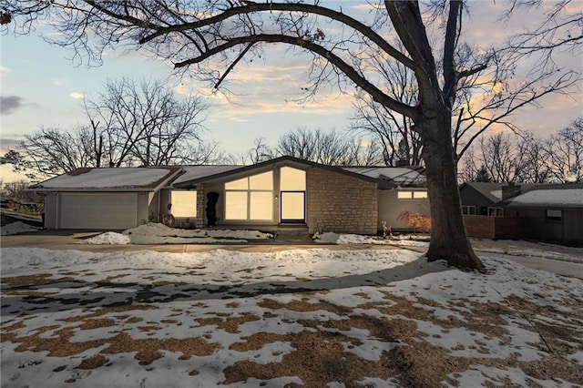 view of snowy exterior with a garage