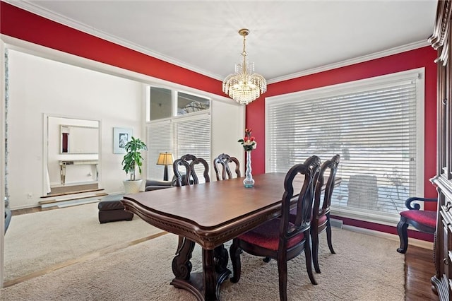 dining room featuring ornamental molding and a chandelier