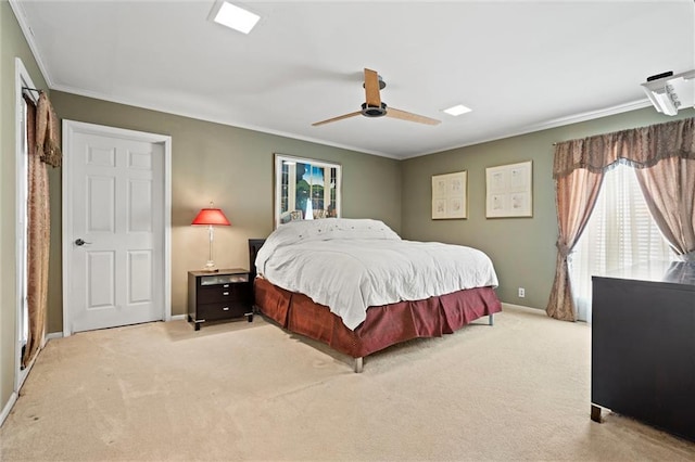 carpeted bedroom featuring crown molding and ceiling fan