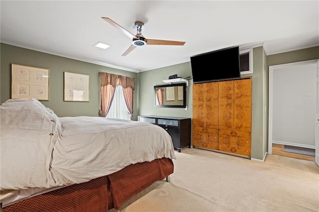 carpeted bedroom featuring ornamental molding, a closet, and ceiling fan