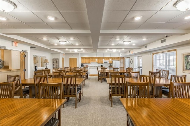 dining room with light colored carpet