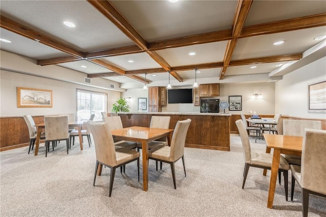 carpeted dining area featuring coffered ceiling, wooden walls, and beamed ceiling