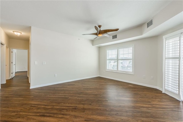 empty room featuring ceiling fan and dark hardwood / wood-style floors