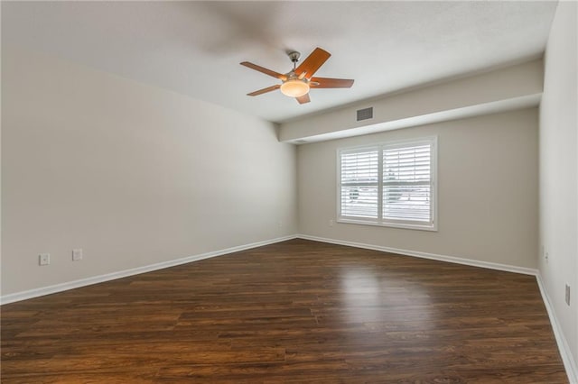 spare room with ceiling fan and dark hardwood / wood-style flooring