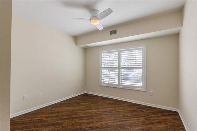 empty room featuring ceiling fan and dark hardwood / wood-style flooring