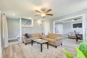 living room featuring light hardwood / wood-style floors and ceiling fan