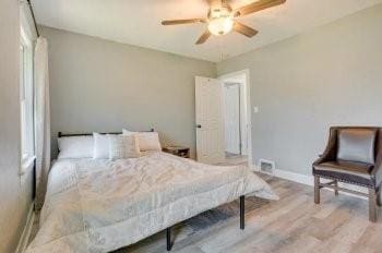 bedroom with light wood-type flooring and ceiling fan