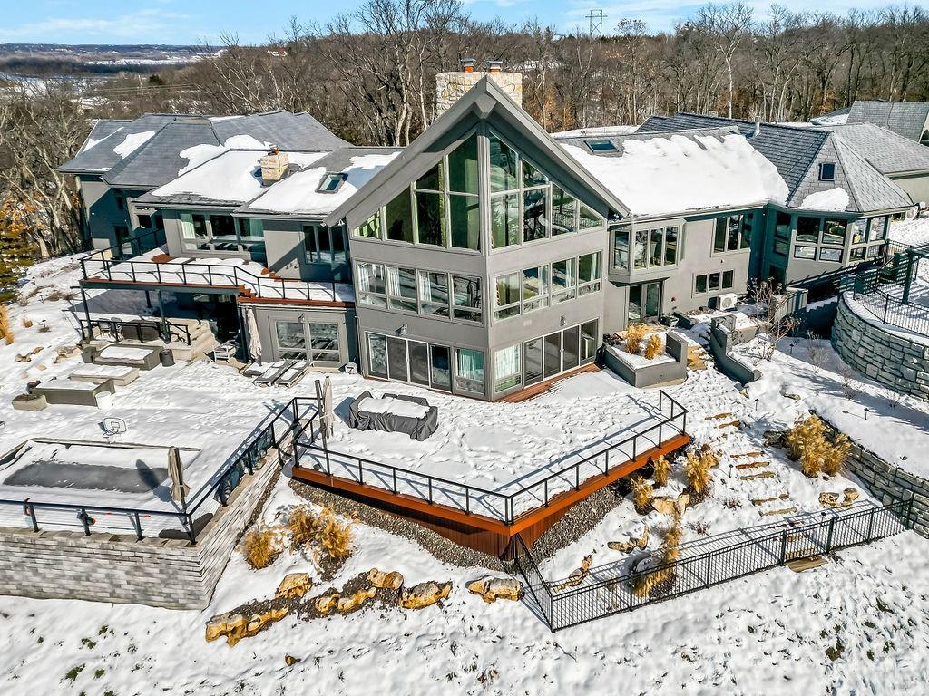 view of snow covered back of property