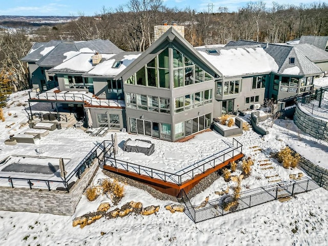 view of snow covered back of property