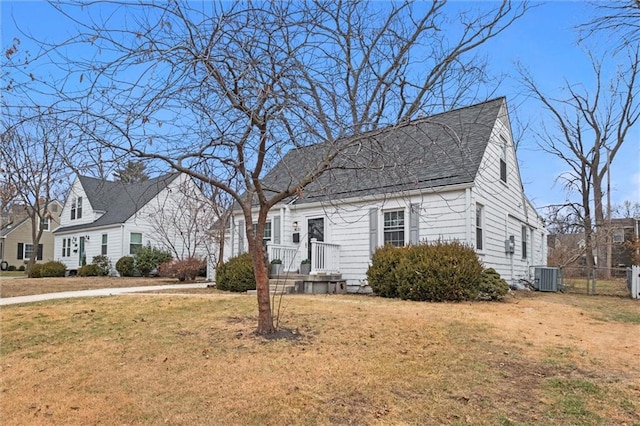 new england style home with a front lawn and central air condition unit