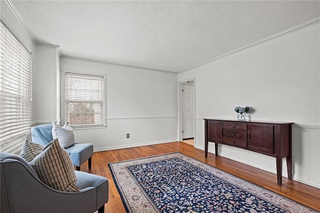 sitting room with hardwood / wood-style flooring and ornamental molding