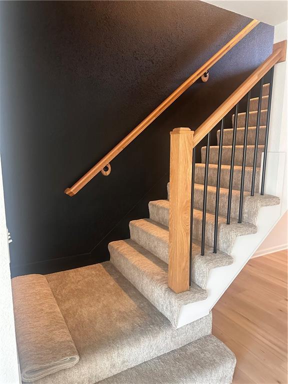 staircase featuring hardwood / wood-style flooring