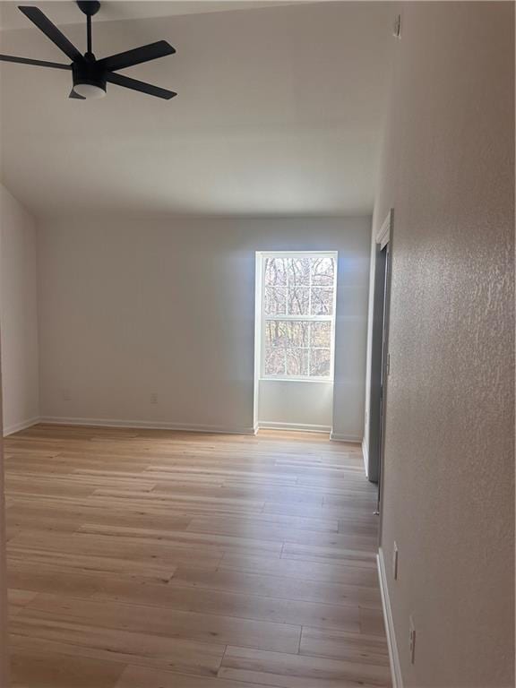 unfurnished room featuring ceiling fan and light hardwood / wood-style floors