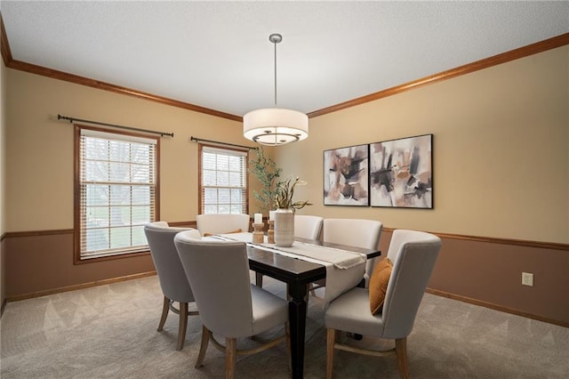 dining area featuring crown molding and light colored carpet