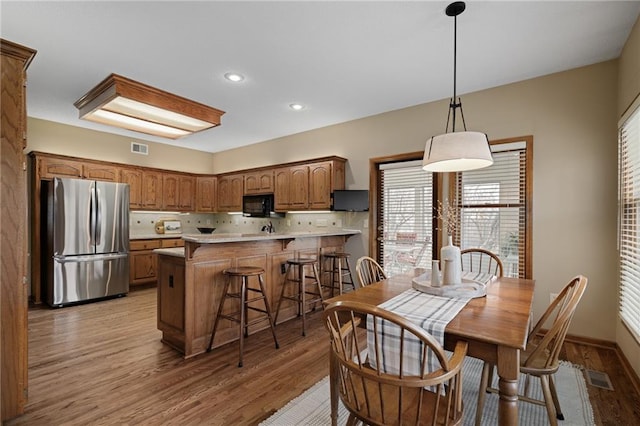 dining space featuring light wood-type flooring