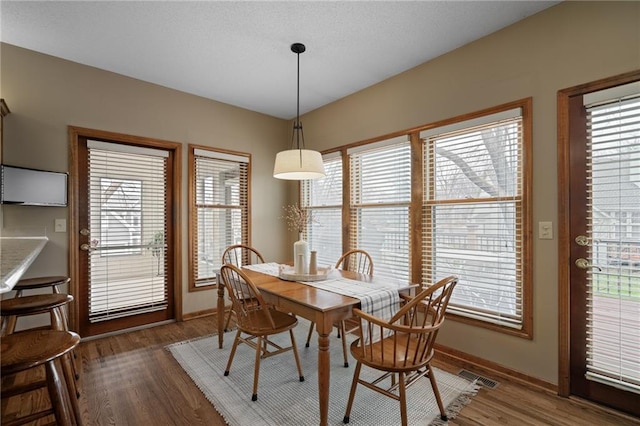 dining area featuring dark wood-type flooring