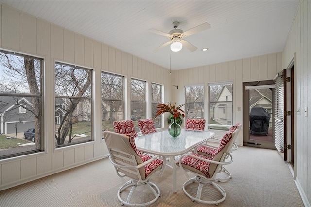 sunroom featuring ceiling fan