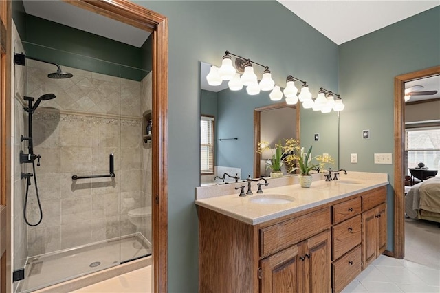 bathroom with vanity, an enclosed shower, and tile patterned flooring