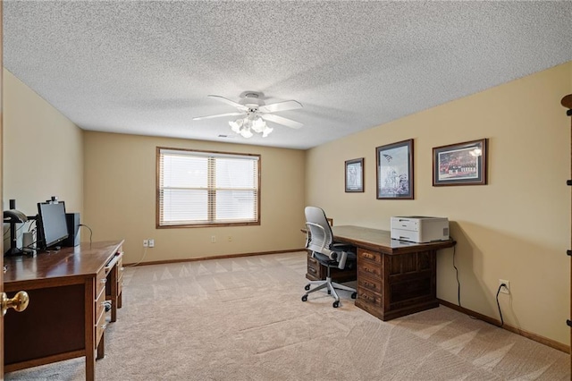 home office featuring light carpet, a textured ceiling, and ceiling fan