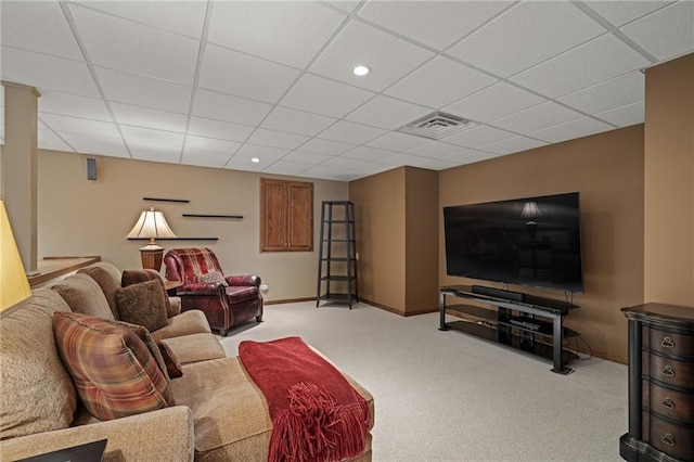 carpeted living room with a drop ceiling