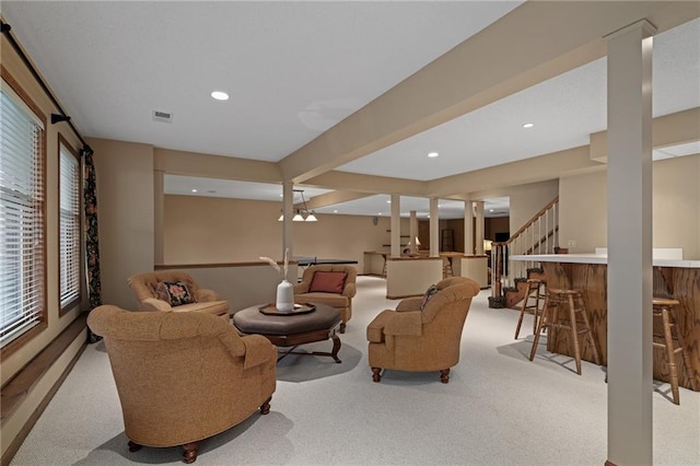 living room with light colored carpet and bar area