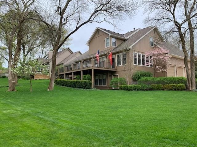 rear view of property featuring a lawn