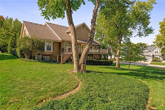 back of property with a wooden deck and a lawn