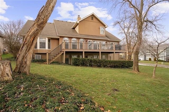 back of property featuring a deck and a lawn