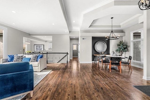 interior space with a notable chandelier, crown molding, and hardwood / wood-style floors