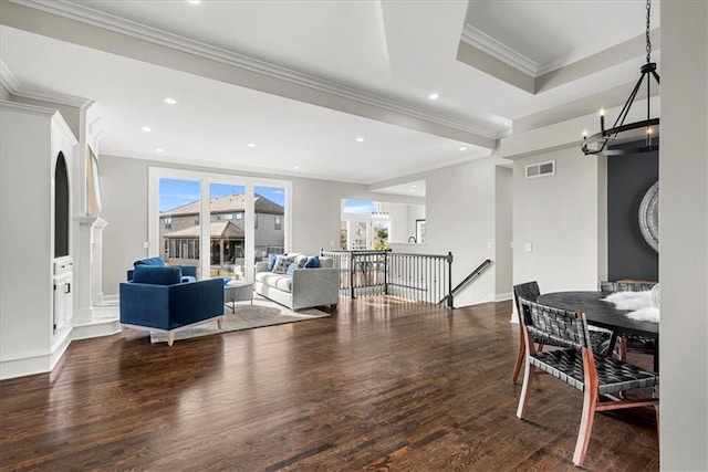 living room with crown molding, a notable chandelier, and dark hardwood / wood-style flooring