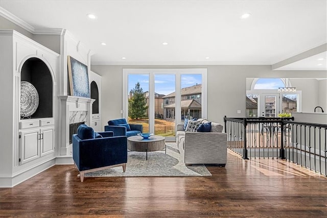 living room featuring ornamental molding, wood-type flooring, and a premium fireplace