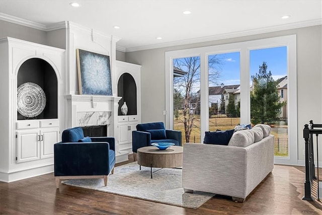 living room with a premium fireplace, ornamental molding, and dark hardwood / wood-style flooring