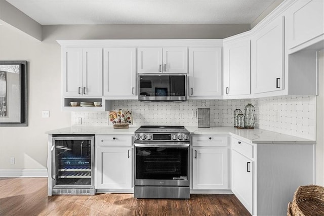 kitchen featuring white cabinetry, stainless steel appliances, light stone counters, tasteful backsplash, and beverage cooler