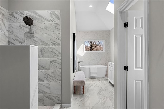 bathroom with vanity, shower with separate bathtub, vaulted ceiling, and tile walls