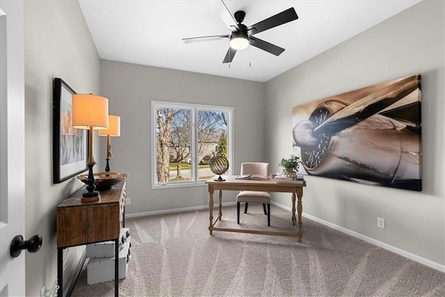 carpeted home office featuring ceiling fan