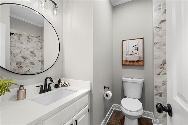 bathroom with vanity, wood-type flooring, ornamental molding, and toilet