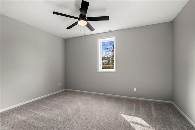 carpeted spare room featuring ceiling fan