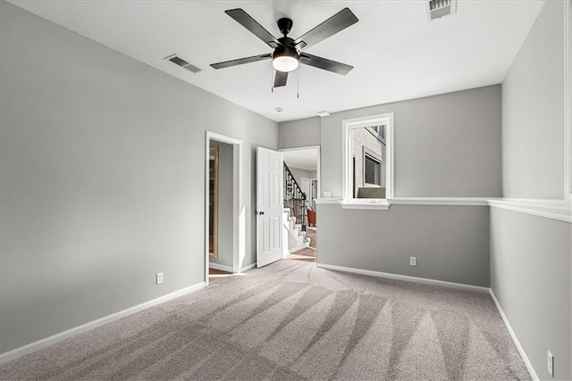 spare room with light carpet and ceiling fan