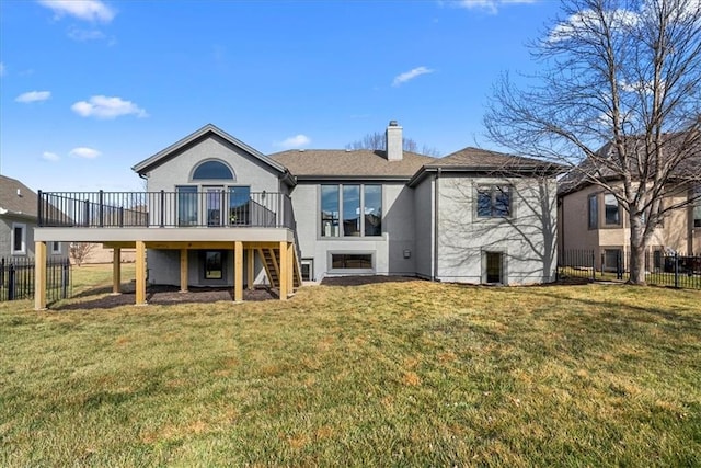 back of property featuring a wooden deck and a yard