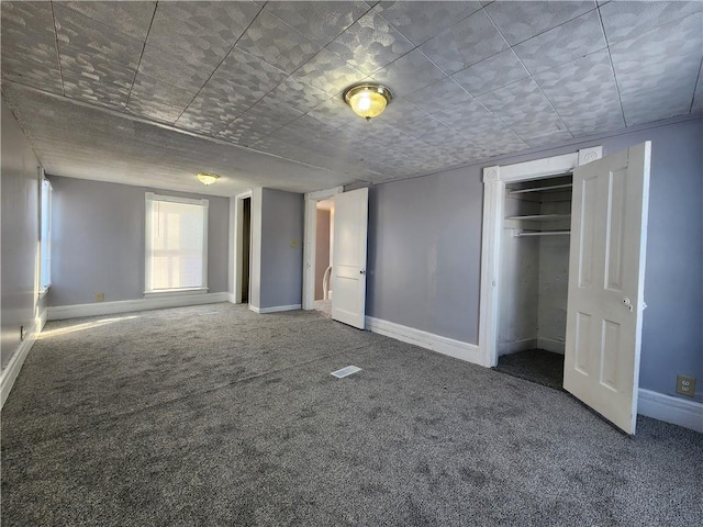 unfurnished bedroom with a closet and carpet flooring