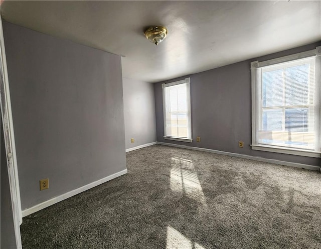 unfurnished room with dark carpet